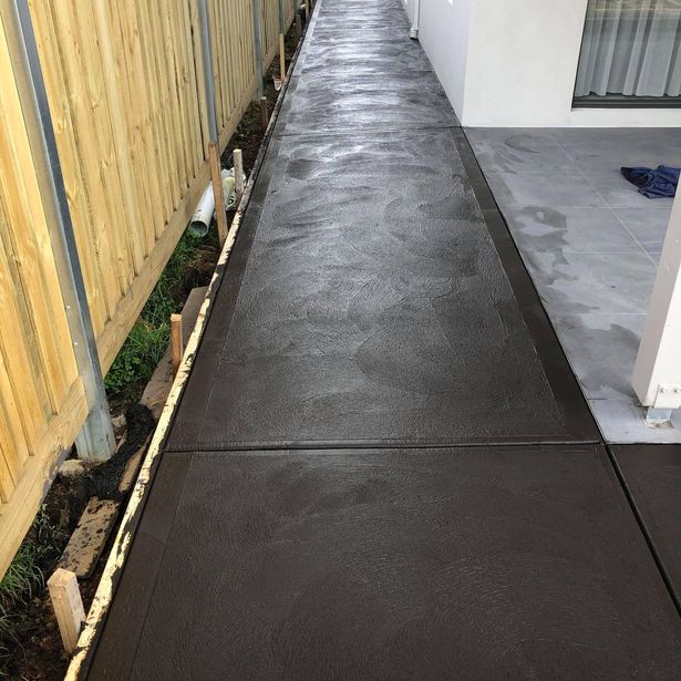 Newly finished concrete foot path with slate impression