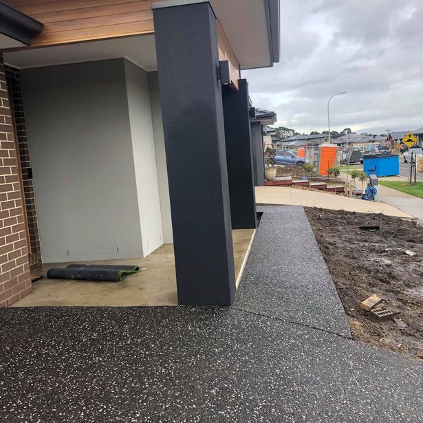 House entrance with concrete path made with exposed aggregate finish