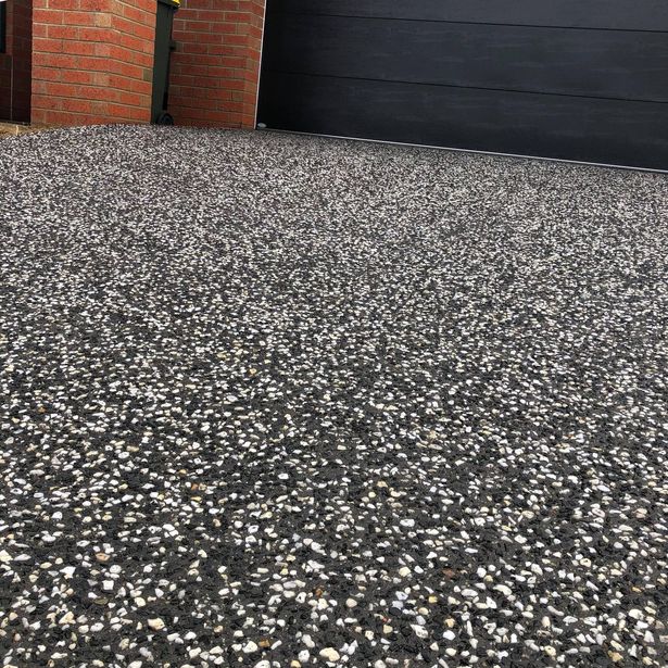 Closed up view of house entrance with concrete path made with exposed aggregate finish