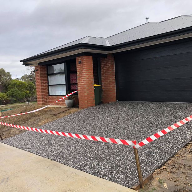 House driveway with exposed aggregate finish in the process of drying
